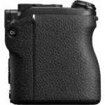 Side view of a black mirrorless camera body with textured grip.