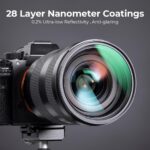 Close-up of a camera lens with 28 layer nanometer coatings on a tripod.