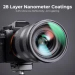 Mirrorless camera with lens on tripod, featuring 28 layer nanometer coatings for low reflectivity and anti-glare.