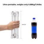 Compact lightweight camera tripod next to a soda bottle for size comparison.