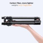 Lightweight carbon fiber camera tripod held in hand, ideal for photography gear.
