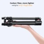 Lightweight carbon fiber camera tripod held in hand, ideal for photography gear.