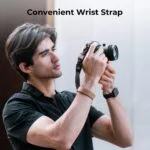 Man using a camera with a convenient wrist strap, photography gear.