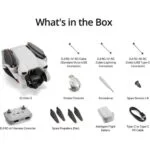 DJI Mini 3 drone with accessories including remote, cables, propellers, and battery.