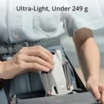 Person holding a DJI drone, ultra-light and compact, ideal for photography and videography.