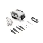 Folded DJI drone with accessories including propellers and screwdriver.