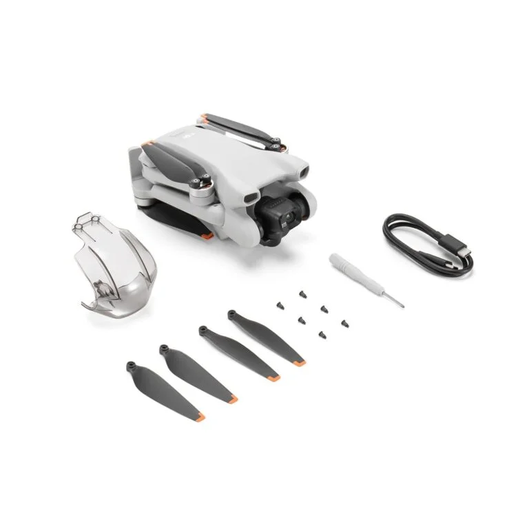 Folded DJI drone with accessories including propellers and screwdriver.