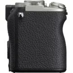 Side view of a compact mirrorless camera body with textured grip.