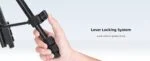 Close-up of a hand adjusting a camera tripod lever locking system.