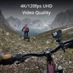 Cyclist using action camera on mountain trail, showcasing 4K video quality.
