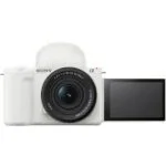 White Sony mirrorless camera with flip-out screen, ideal for vlogging and photography.