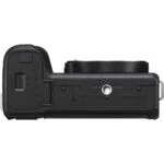 Bottom view of a mirrorless camera body with battery compartment and tripod mount.