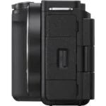 Side view of a black mirrorless camera body with textured grip.