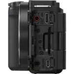 Side view of a digital camera body showing various ports and connections.