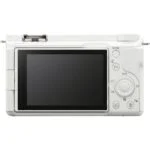 Back view of a white mirrorless camera with LCD screen and control buttons.
