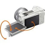 White mirrorless camera with tilting LCD screen, ideal for photography enthusiasts.