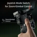 Close-up of a camera gimbal with joystick mode switch for zoom control.
