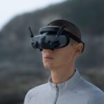 Person wearing DJI drone goggles outdoors.