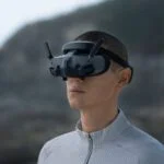 Person wearing DJI drone goggles outdoors.