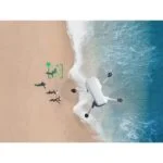 Drone flying over a beach capturing aerial footage.