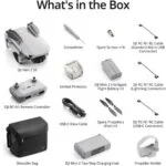 DJI Mini 2 SE drone package with accessories including remote, cables, and spare parts.
