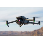 DJI drone flying over a desert landscape, showcasing advanced camera features.