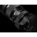 Close-up of a professional camera lens on a DSLR body, ideal for photography enthusiasts.