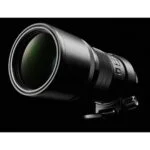 Professional telephoto camera lens on black background, ideal for wildlife and sports photography.