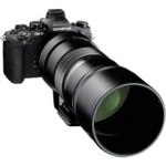 Olympus mirrorless camera with large lens, ideal for professional photography.