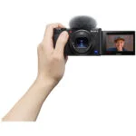 Sony digital camera with flip screen displaying a person, ideal for vlogging and photography.