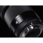 Close-up of a Sigma 30mm f/1.4 DC DN lens for mirrorless cameras.