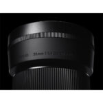 Close-up of a Sigma 30mm f/1.4 DC DN lens, ideal for mirrorless cameras.