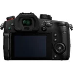 Back view of a digital mirrorless camera with LCD screen and control dials.