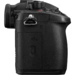 Side view of a professional DSLR camera body with textured grip and SD card slot.