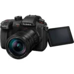 Panasonic Lumix GH5 II mirrorless camera with lens and flip screen.