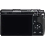 Back view of a Ricoh digital camera with screen and control buttons.