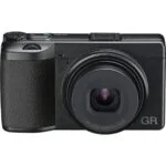 Compact digital camera with lens, ideal for photography enthusiasts in the UK.