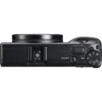 Top view of a compact digital camera with control dial, ideal for photography enthusiasts.