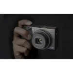 Compact digital camera held in hand, ideal for photography enthusiasts.