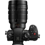 Panasonic mirrorless camera with lens, top view, available at Camix UK.