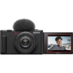 Sony digital camera with flip screen displaying a smiling person, ideal for vlogging and photography.