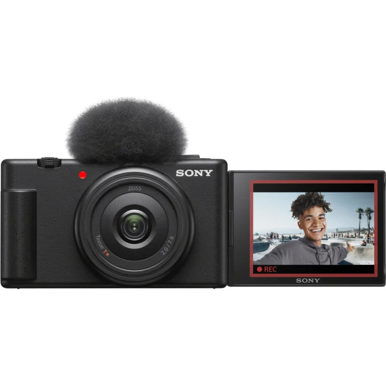 Sony digital camera with flip screen displaying a smiling person, ideal for vlogging and photography.