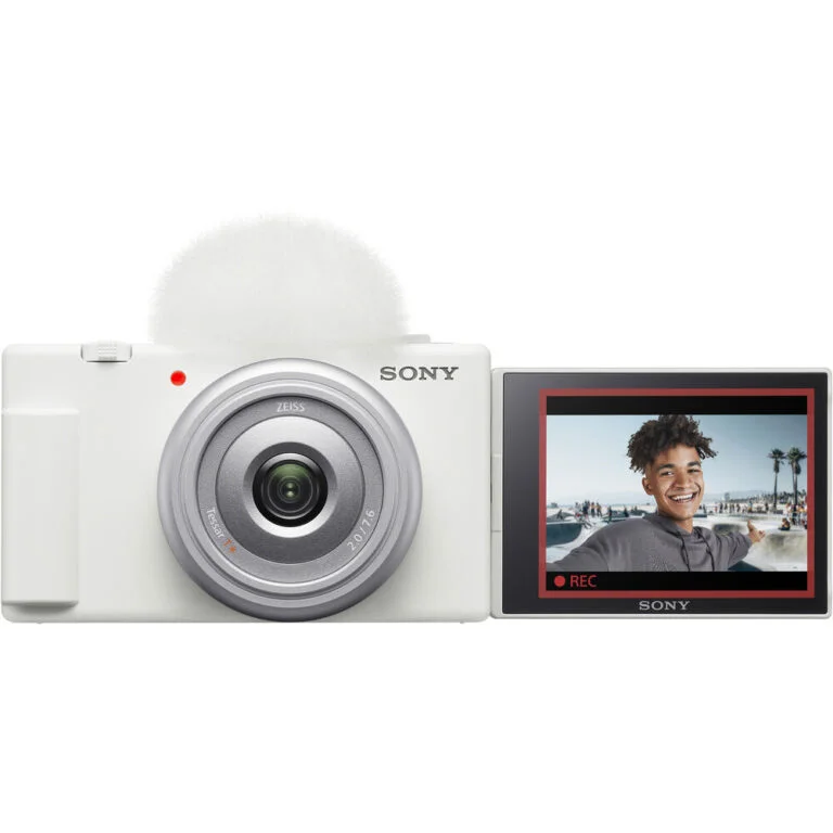 Sony digital camera with flip-out screen displaying a smiling person, ideal for vlogging and photography.