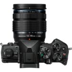 Top view of a mirrorless camera with a 12-45mm lens, featuring control dials and buttons.
