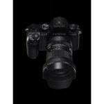 Fujifilm X-S10 mirrorless camera with lens on black background.