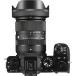 Top view of a Sigma 18-50mm lens on a camera body, showcasing photography gear.