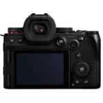Back view of a mirrorless camera with LCD screen and controls, available at a UK camera shop.