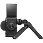 Sony digital camera with flip screen and tripod, ideal for vlogging and photography.