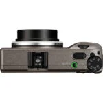 Top view of a compact digital camera with control dial and lens, ideal for photography enthusiasts.
