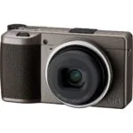 Compact digital camera with textured grip and lens, ideal for photography enthusiasts.